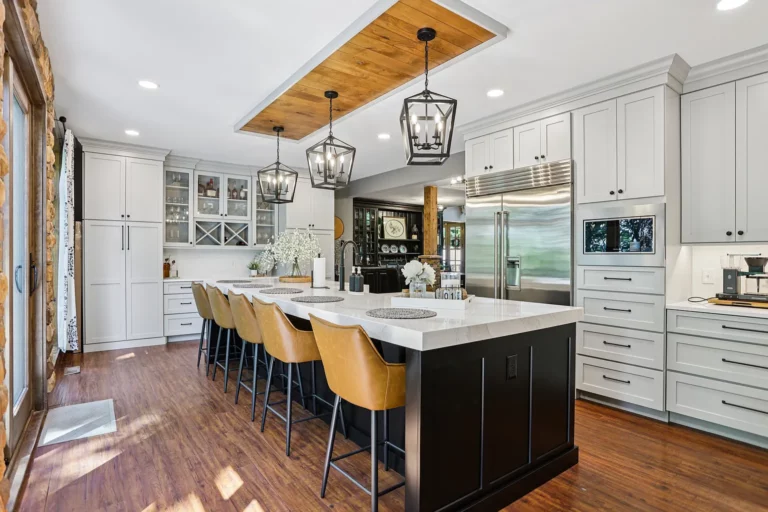 Kitchen island with pendant lighting and a wood-clad ceiling inset